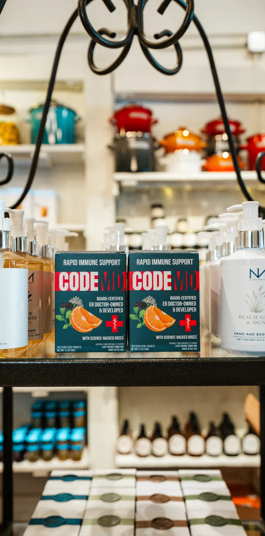 Two boxes of CODE RED+ Rapid Immune Support hand sanitizers displayed on a store shelf alongside other personal care products.